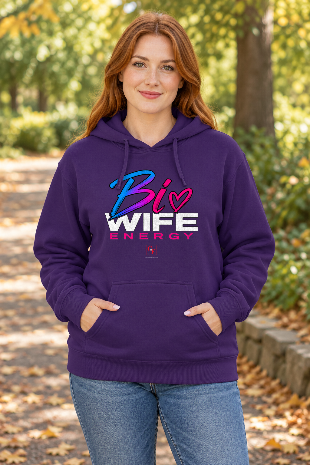 Woman wearing the Purple Bi Wife Energy hoodie in an outdoor lifestyle setting