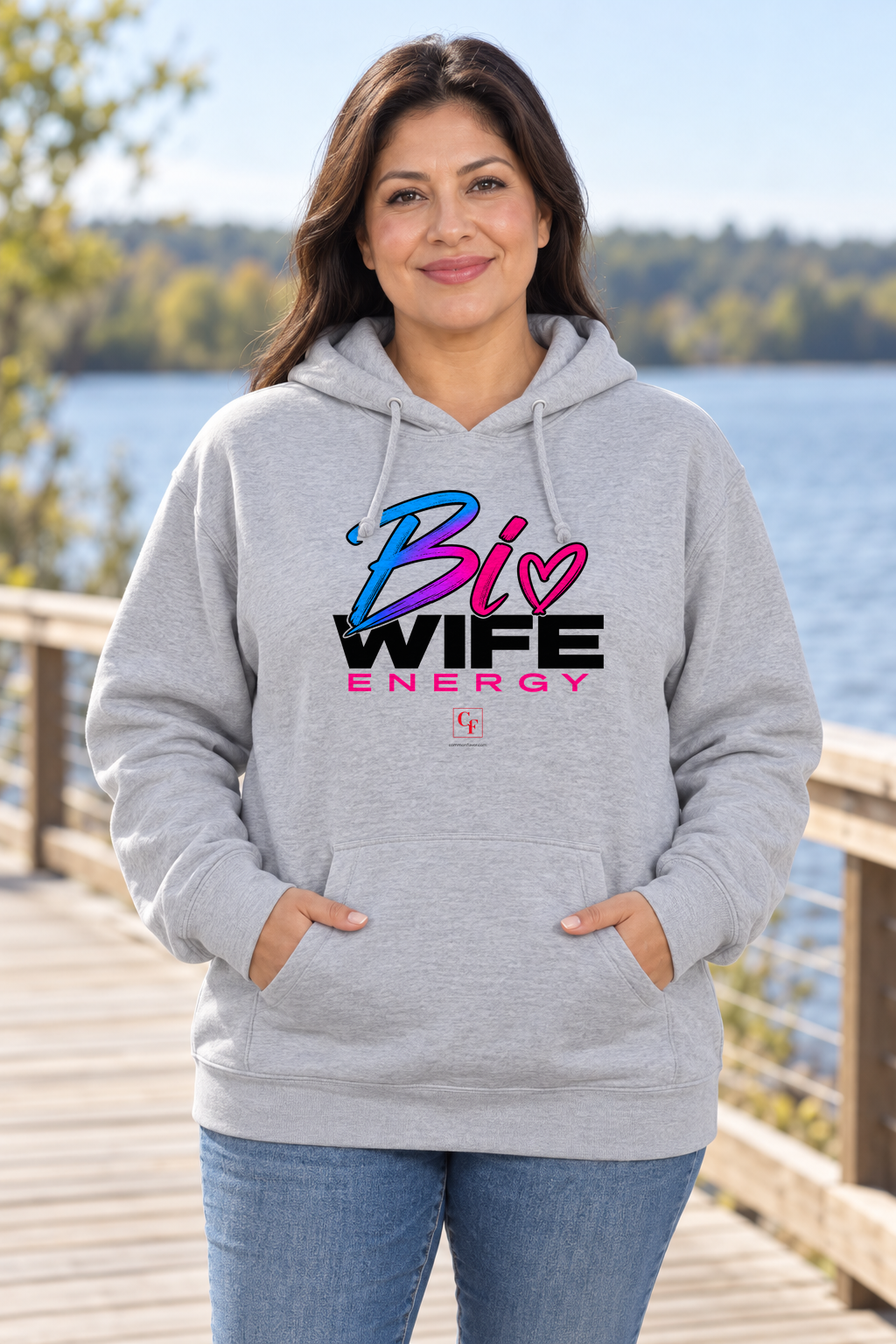 Woman wearing the Sport Grey Bi Wife Energy hoodie in an outdoor lifestyle setting