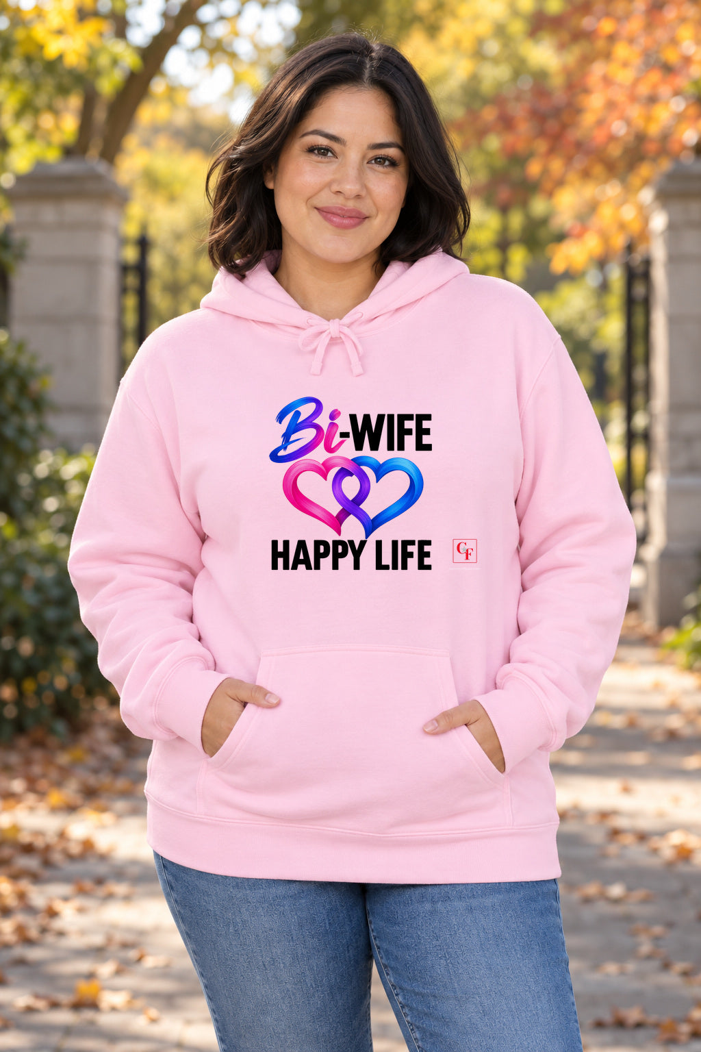Bi Wife Happy Life Hoodie in Light Pink on a model outdoors — Common Flavor