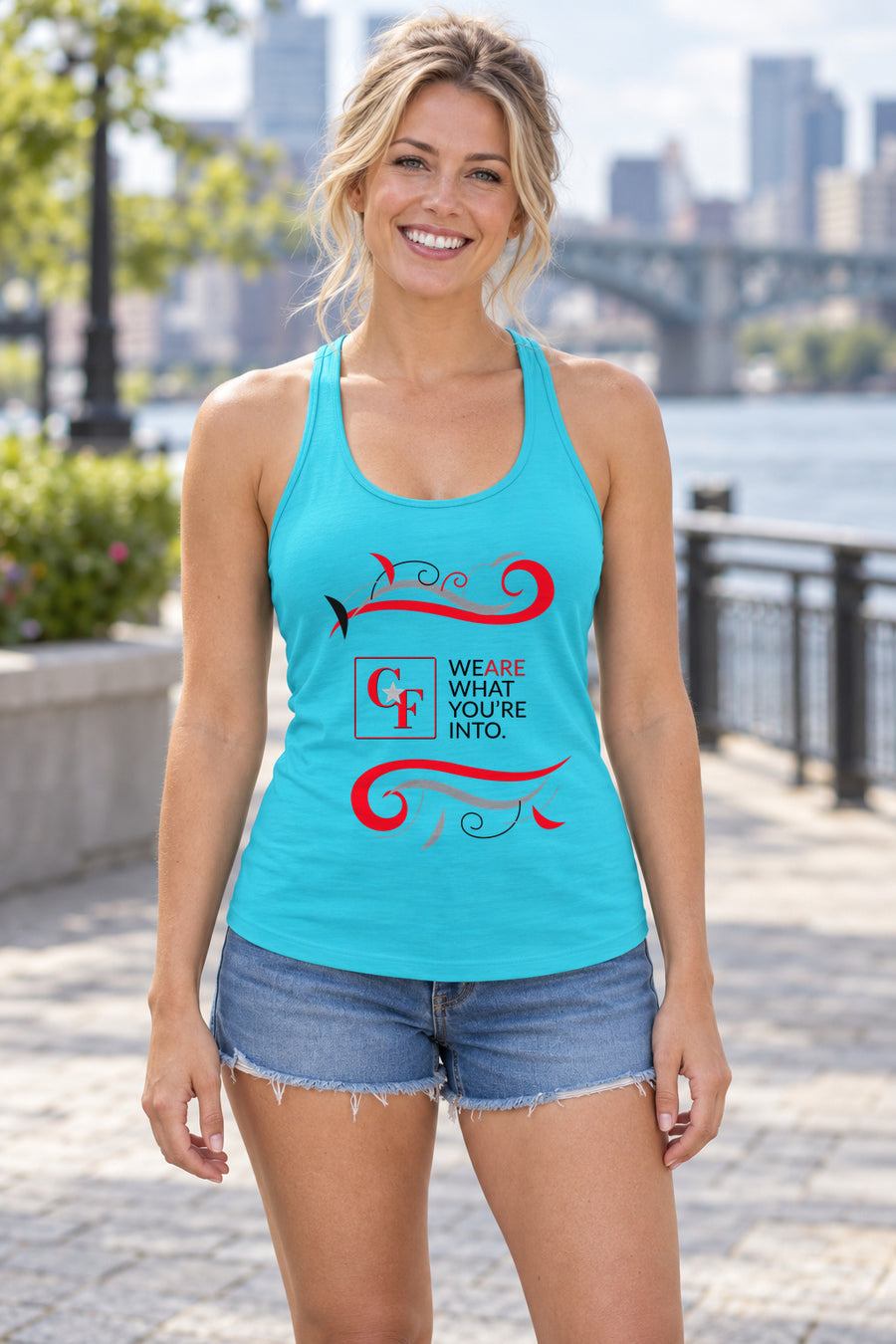 CF Originals "We Are What You're Into" Flowing Twist Racerback Tank in Tahiti Blue, woman wearing the tank in a lifestyle setting