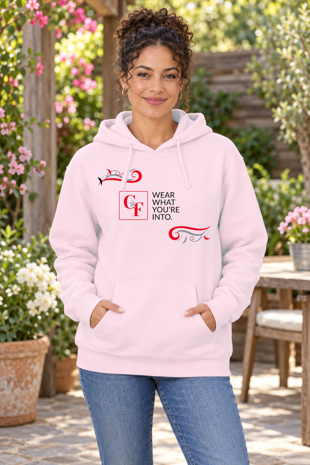 CF Originals "Wear What You're Into" Flowing Twist Hoodie in Light Pink on a model outdoors — Common Flavor