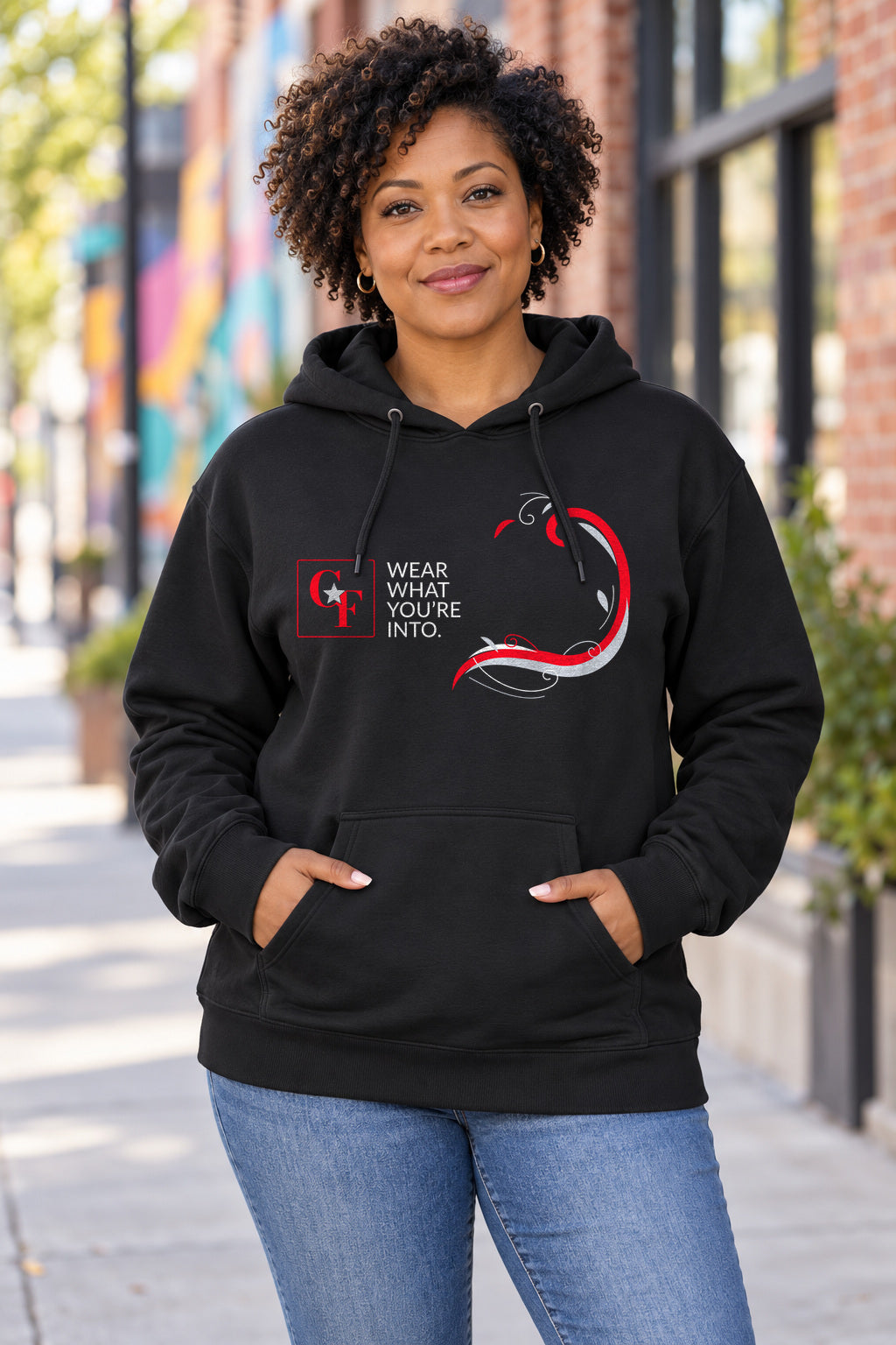 Common Flavor Originals "Wear What You're Into" Side Sweep Hoodie in Black on a model outdoors — Common Flavor