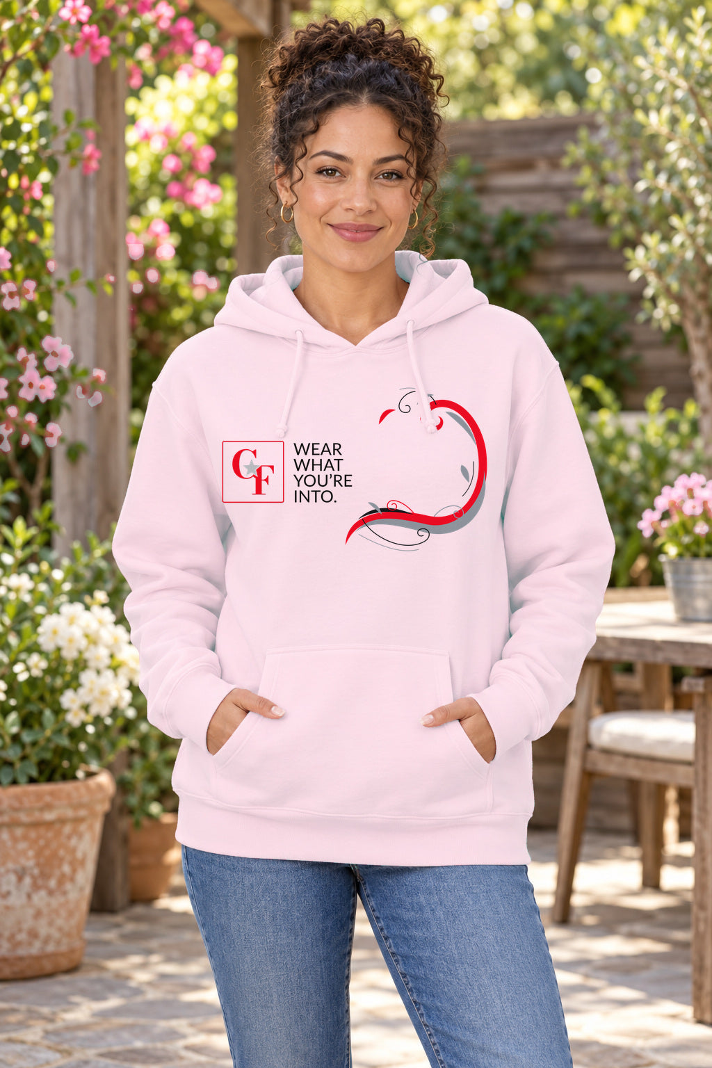 Common Flavor Originals "Wear What You're Into" Side Sweep Hoodie in Light Pink on a model outdoors — Common Flavor