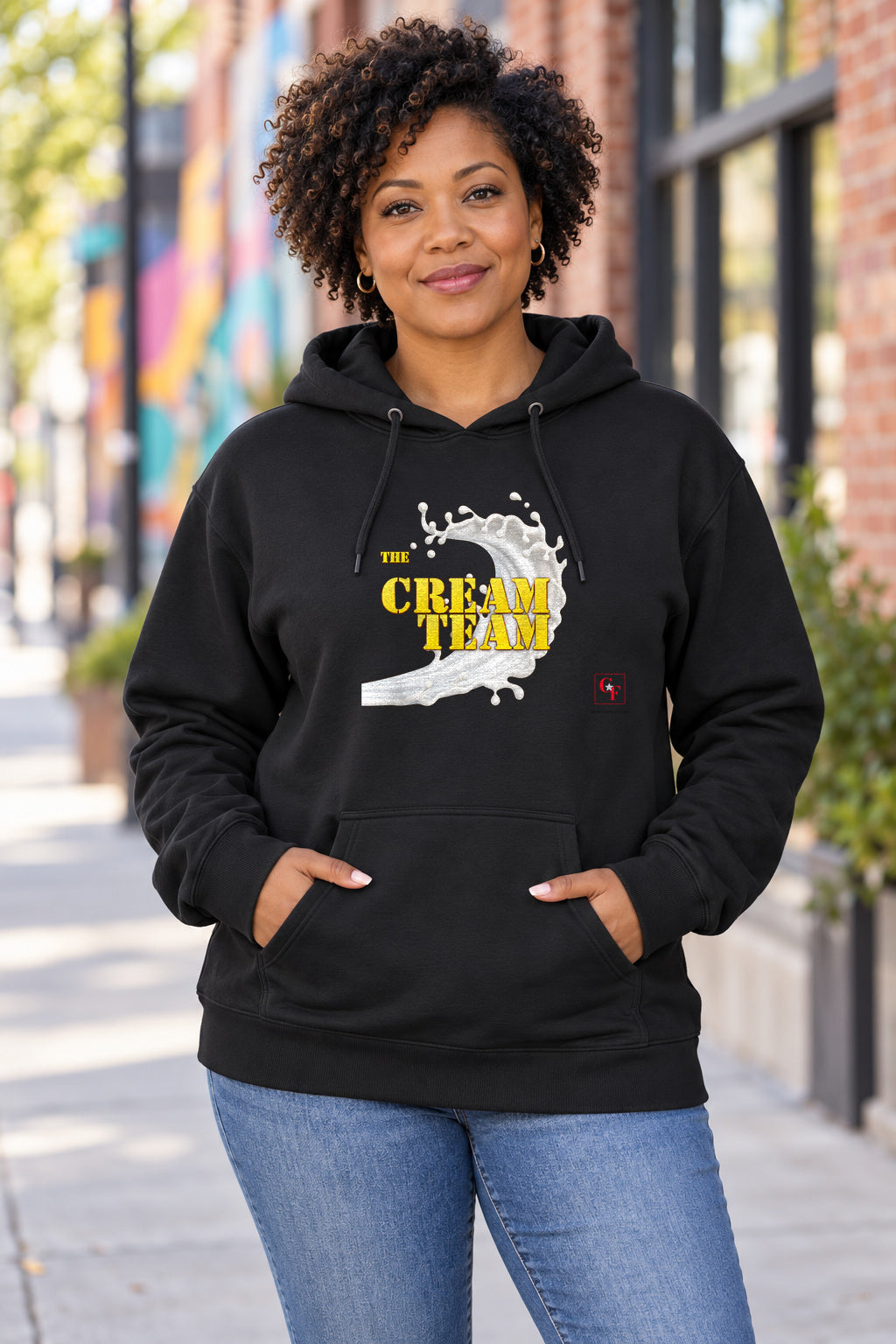 Cream Team Original Refresh Hoodie in Black on a model outdoors — Common Flavor