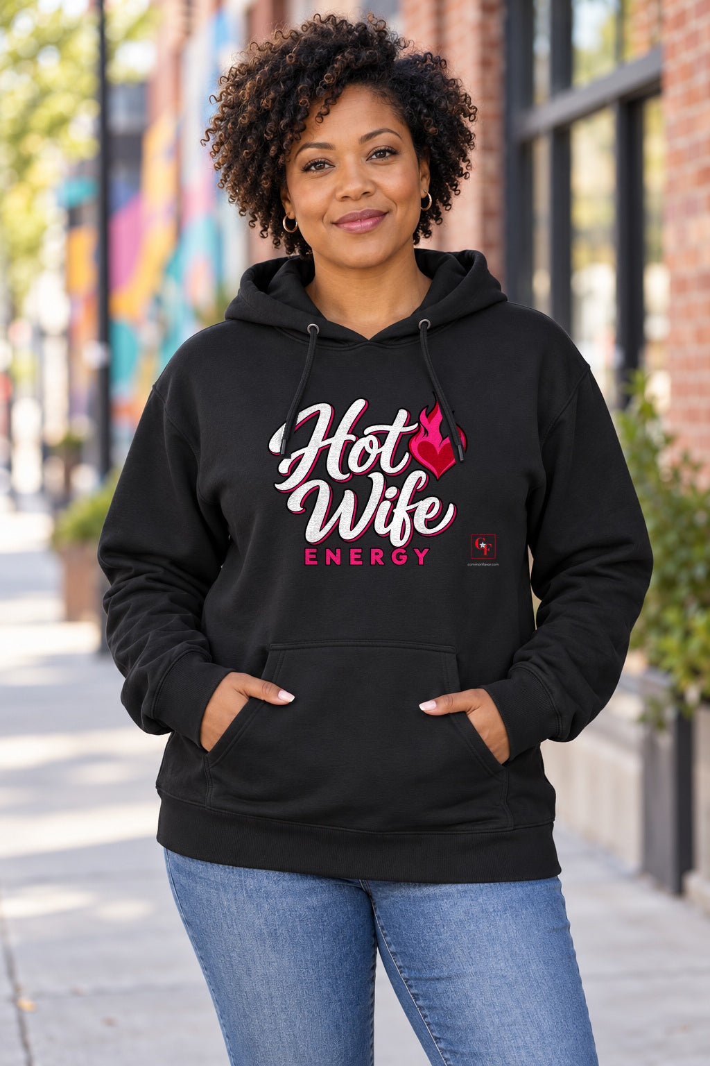 Hot Wife Energy Hoodie in Black on a model outdoors — Common Flavor