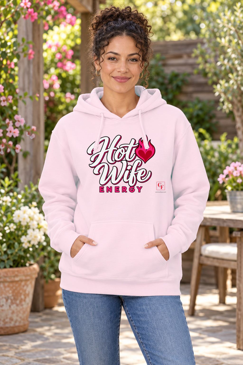 Hot Wife Energy Hoodie in Light Pink on a model outdoors — Common Flavor