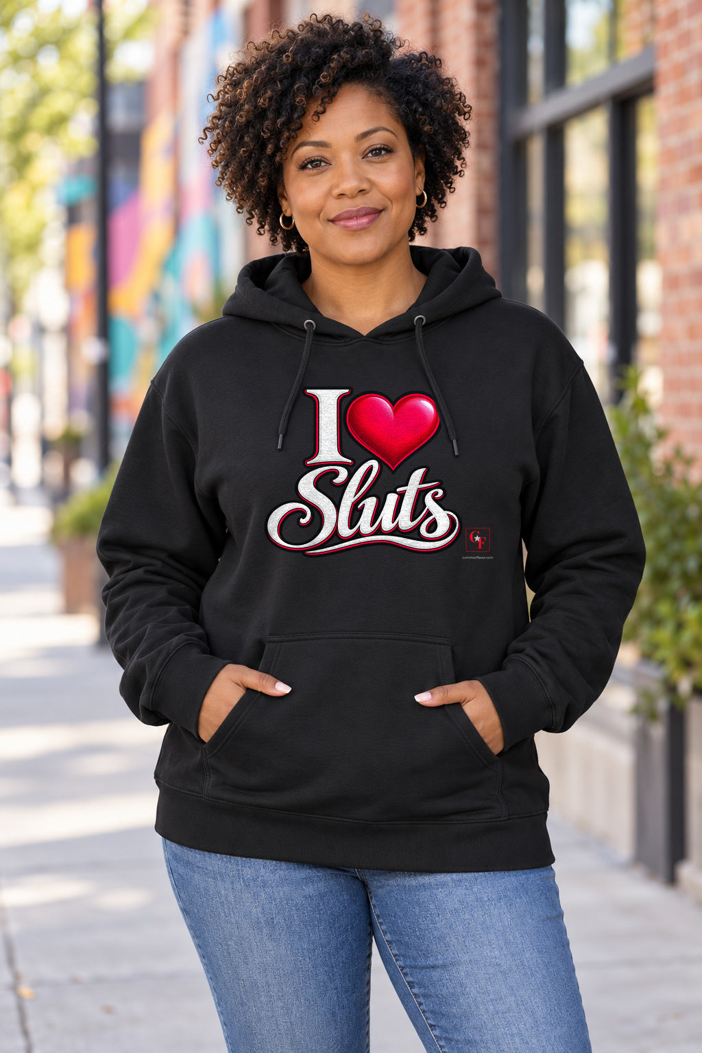 I Heart Sluts Hoodie in Black on a model outdoors — Common Flavor