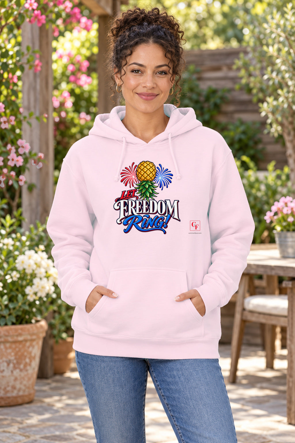 Let Freedom Ring Hoodie in Light Pink on a model outdoors — Common Flavor