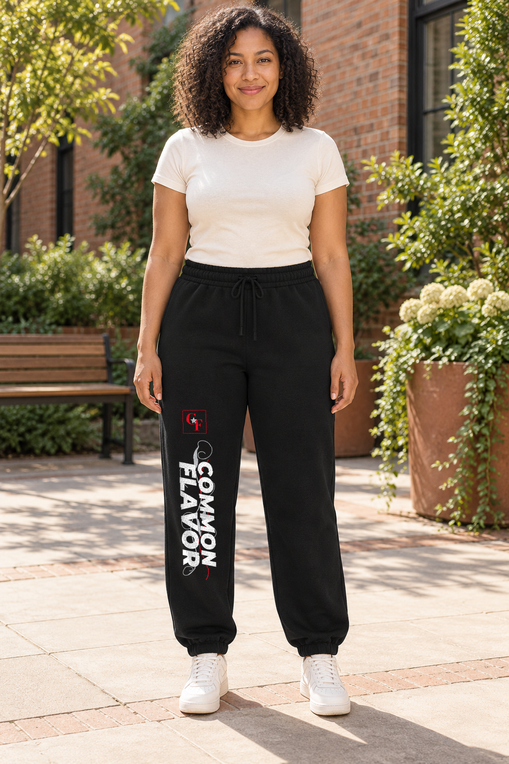 Model wearing Black Common Flavor Sweeping Swirl sweatpants outdoors