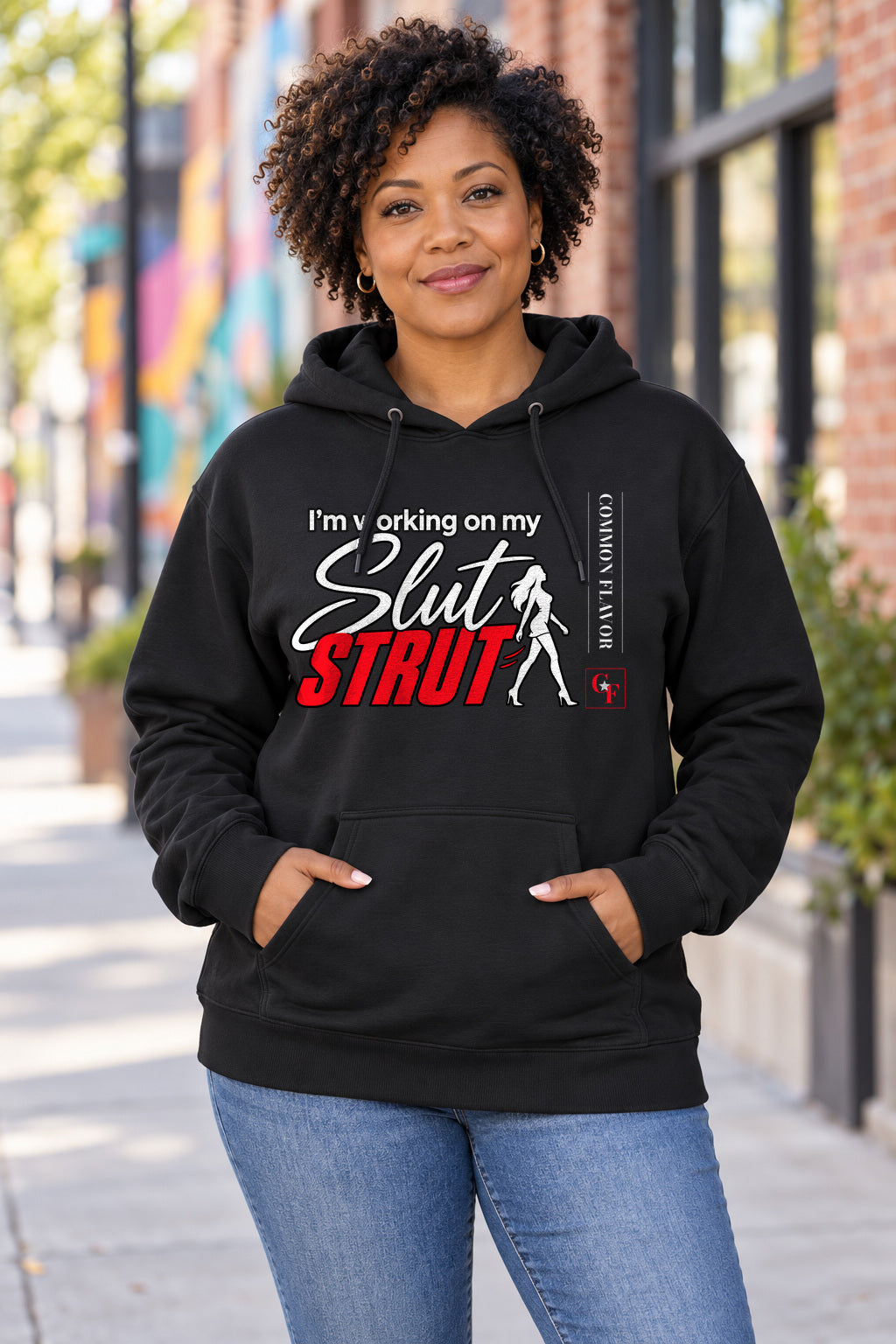 Slut Strut Variation Hoodie in Black on a model outdoors — Common Flavor