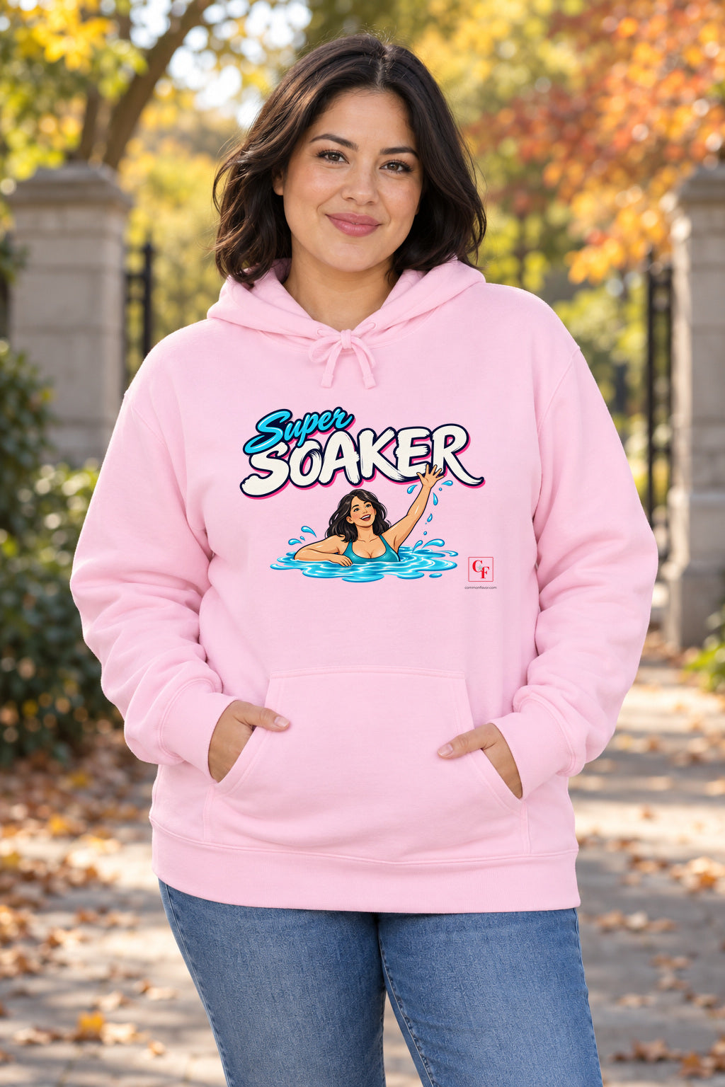 Super Soaker Female Hoodie in Light Pink on a model outdoors — Common Flavor