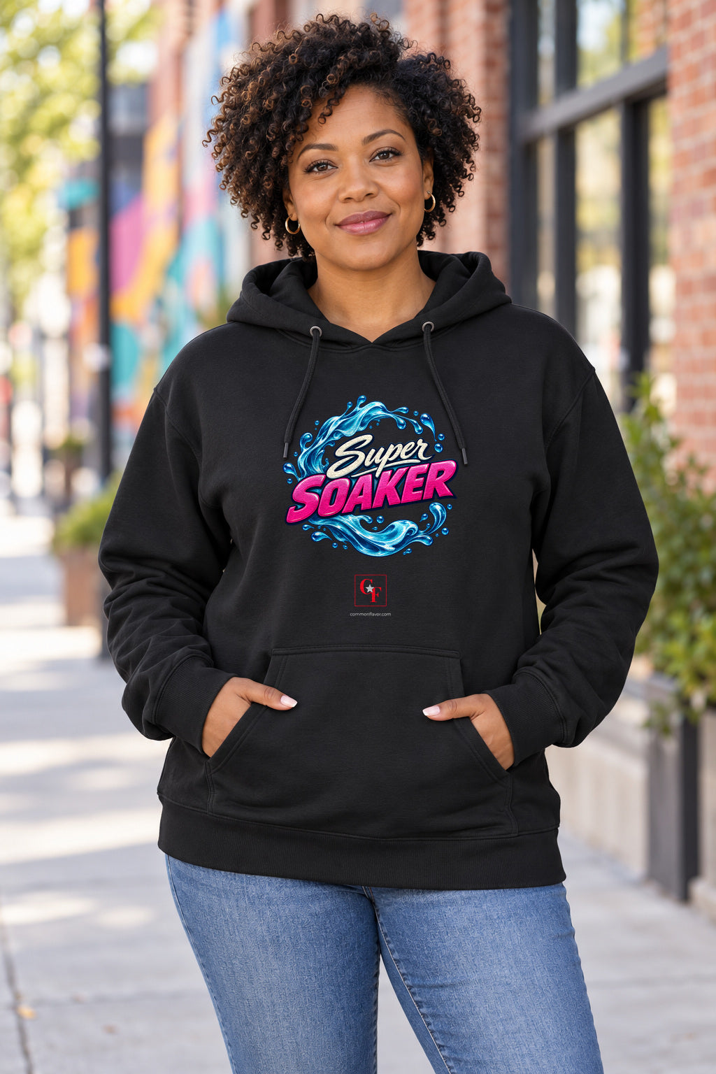 Super Soaker Hoodie in Black on a model outdoors — Common Flavor